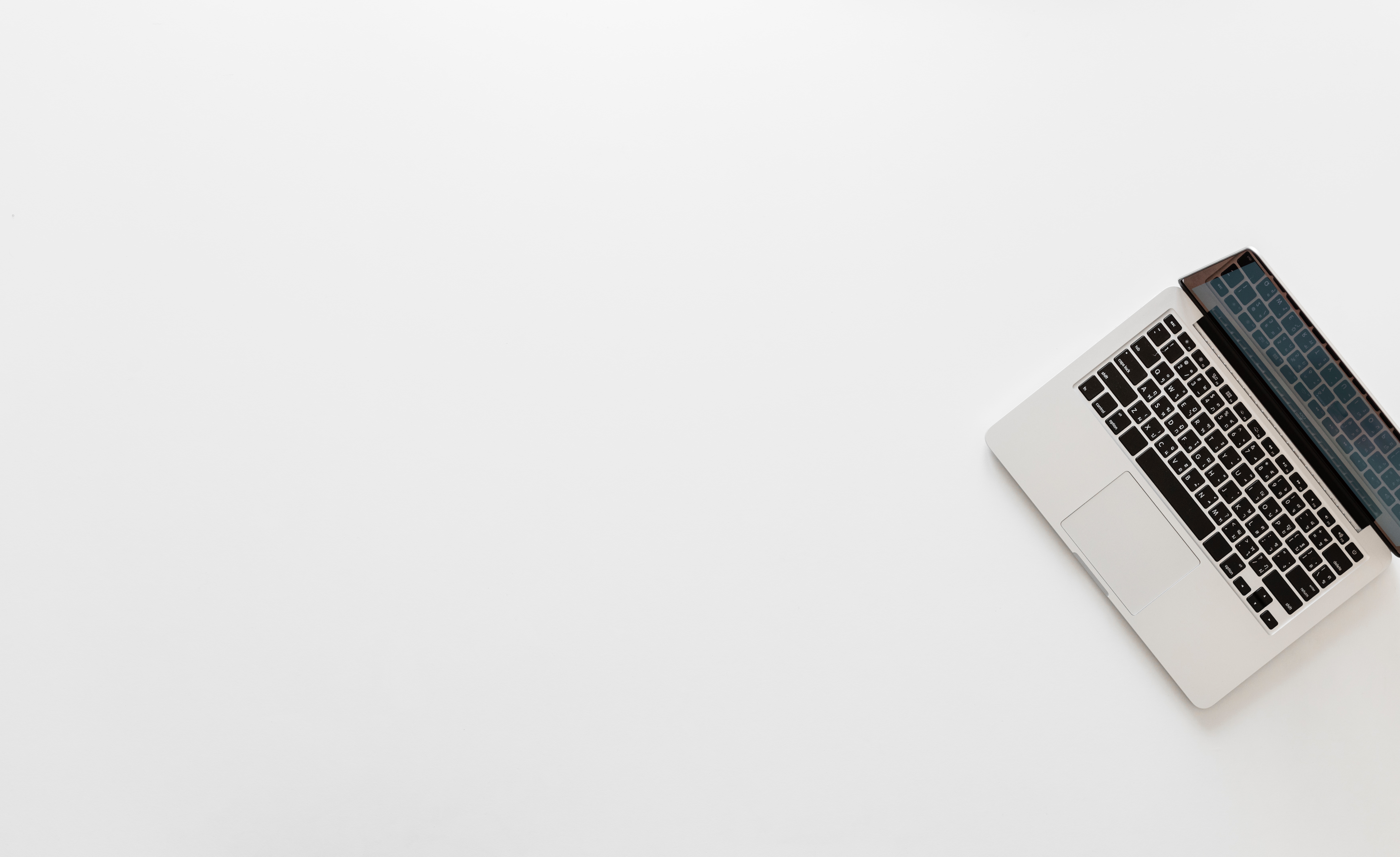 laptop on a white desk by rawpixel on Unsplash